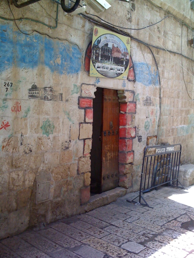 Red decoration around doorway indicates that inhabitant of this house has made pilgrimage to Mecca. Street in Old City Jerusalem.